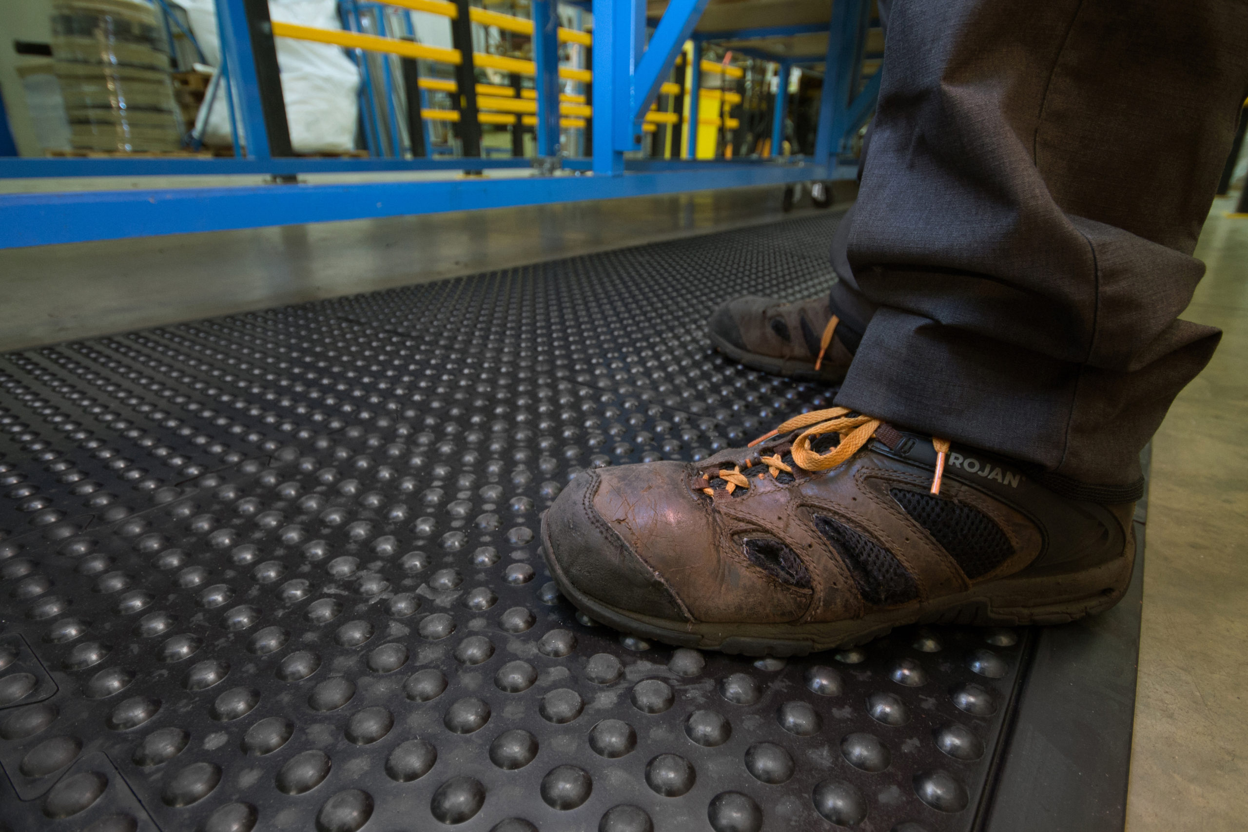 Man standing on Bubbled Detailed Anti-Fatigue Interlocking Tiles