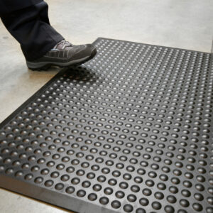 Person stepping on a black Bubbled Detailed Mat