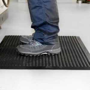 Woman standing on a black Electrostatic Discharge Mat