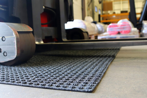 Close up image of grey Heavy High Performance Superdry Doormat on a carpet