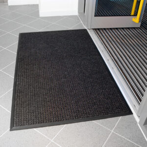 Black High Performance Superdry Doormat outside a building entrance