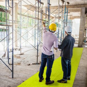 Builders stood on high visibility path at construction site