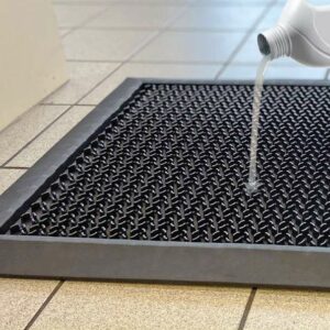 Liquid being poured on a Hygienic Floor Mat