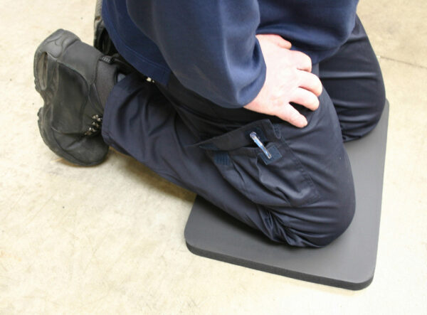 Man kneeling on a black Knee Protector Mat