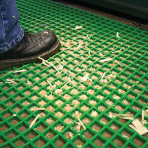 Man standing on green Light Duty Woven PVC Mat