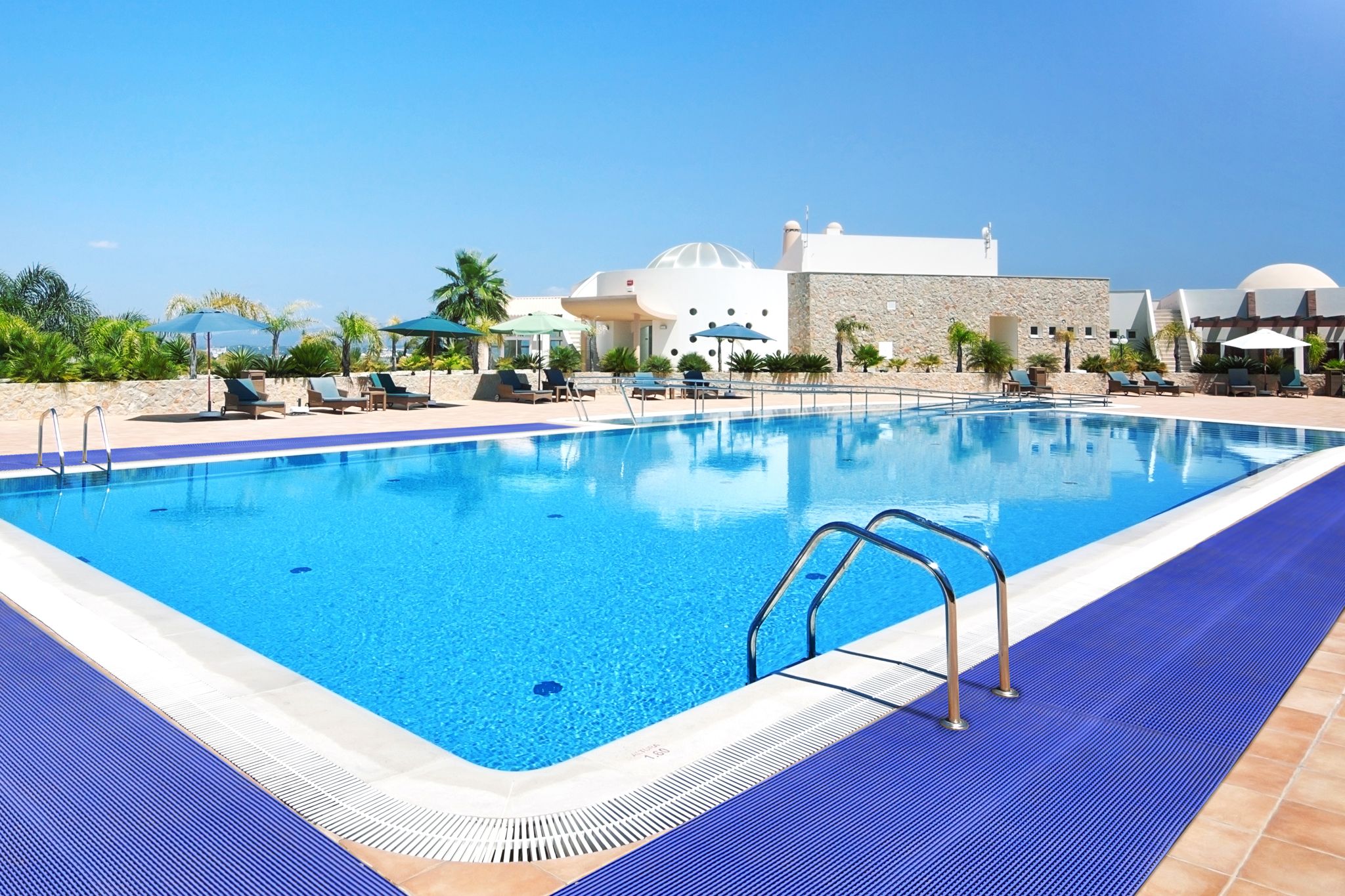 Blue mat surrounding a swimming pool