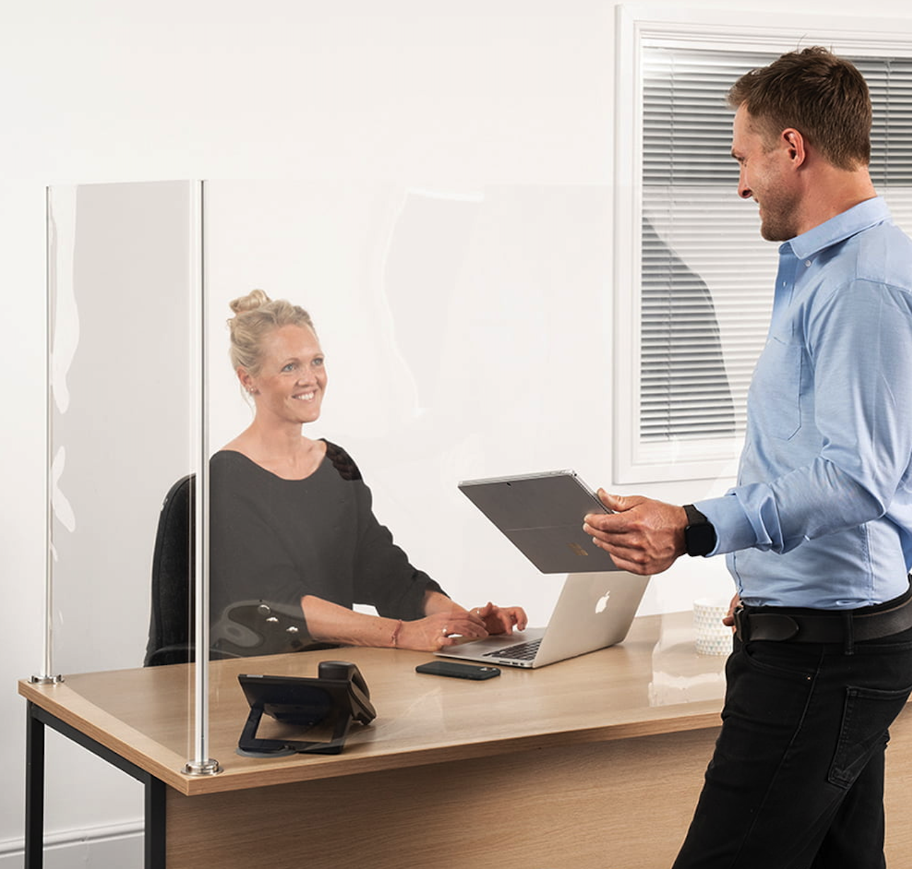 conversation between man and woman behind an L Shape Safety Screen