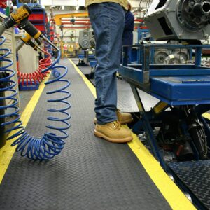 Man standing on a roll of Safety Diamond Detailing Mat