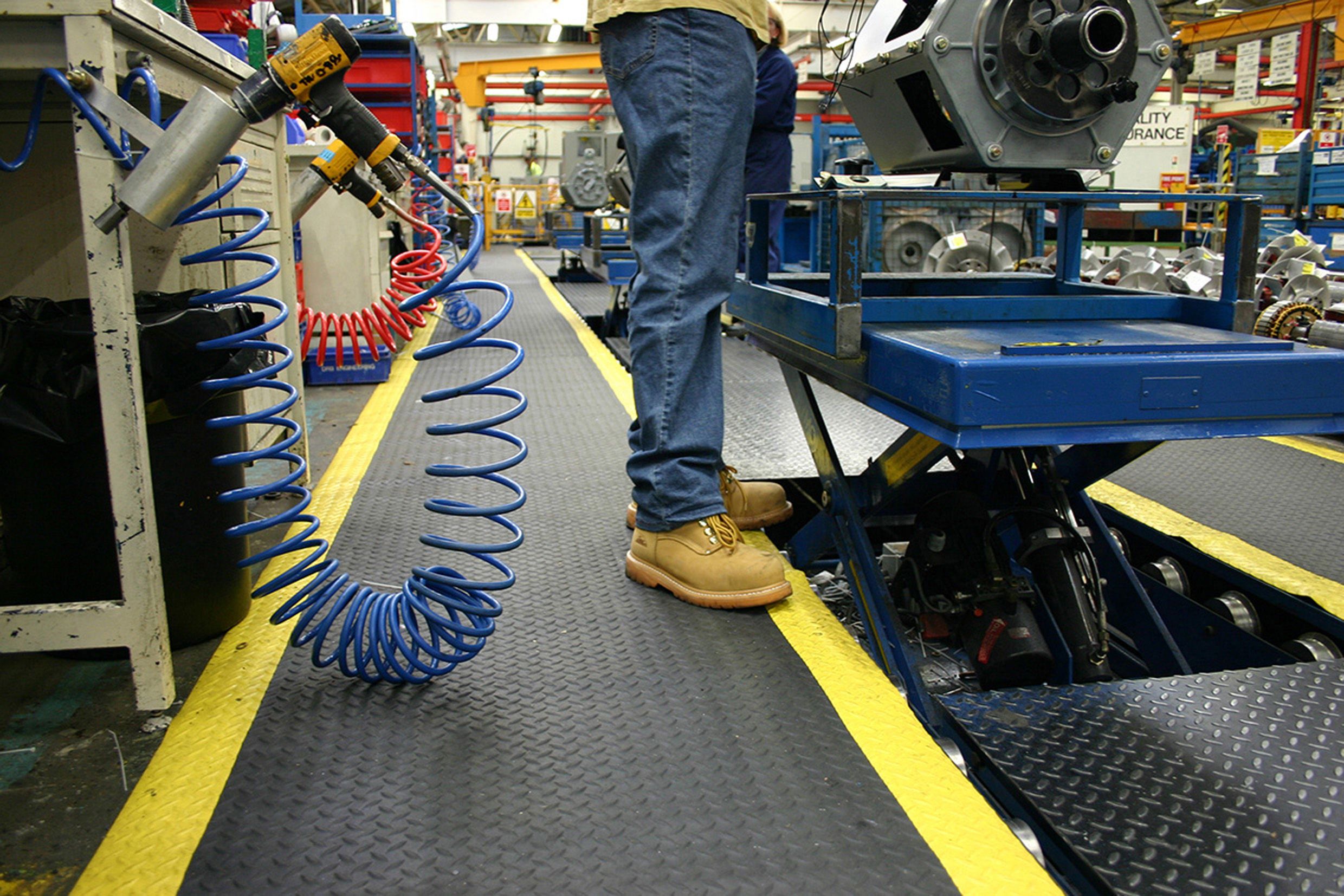 Man standing on a roll of Safety Diamond Detailing Mat